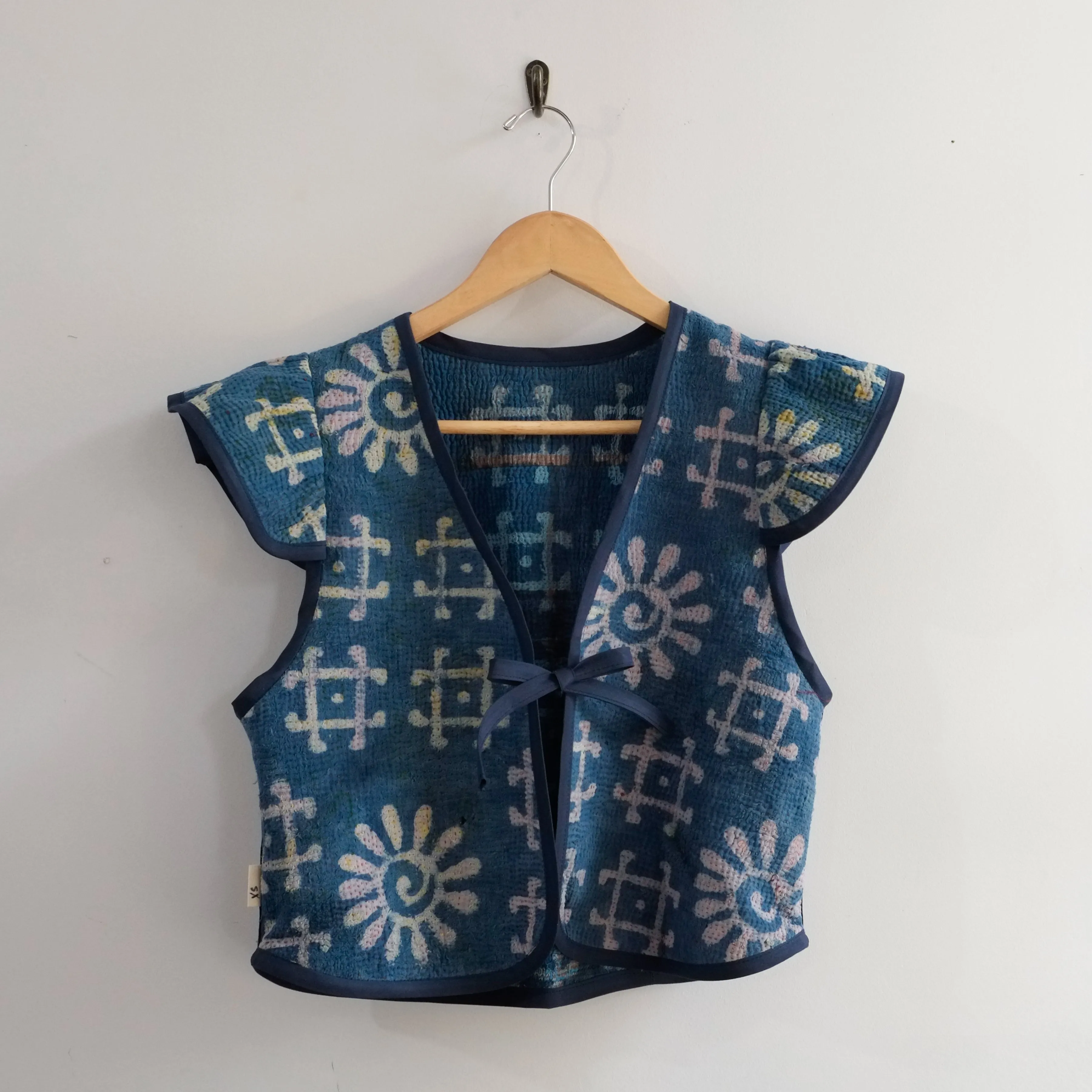 Amelia Flutter Sleeve Vest Indigo with Pound Symbol XS009